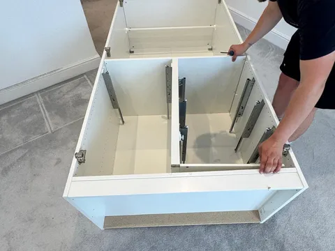 Reliable Removals mover rebuilding a flat pack chest of drawers
