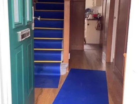 Hallway and staircase covered with protective floor film before a house move