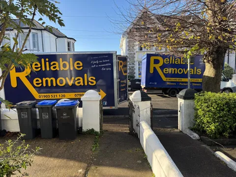Two Reliable Removals vans working a move on a Worthing residential street