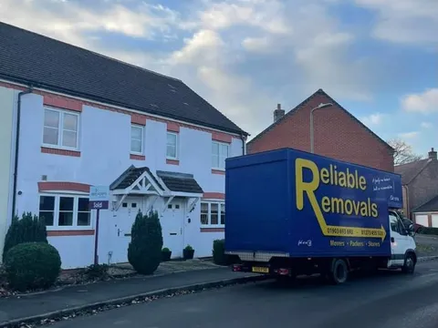 Reliable Removals van outside a sold new build home